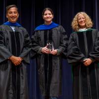 Faculty holding award with Robert Smart and Provost Drake